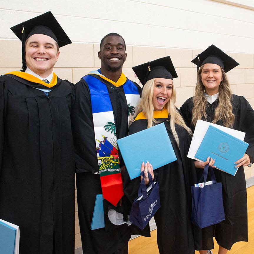 Affordable Immaculata University Degrees - four students smiling after graduation
